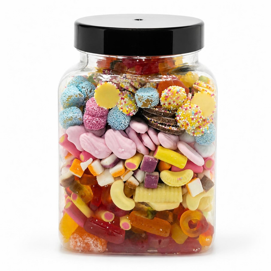 A clear plastic jar filled with assorted colorful candies and sweets, topped with a black screw-on lid, photographed on a white background.
